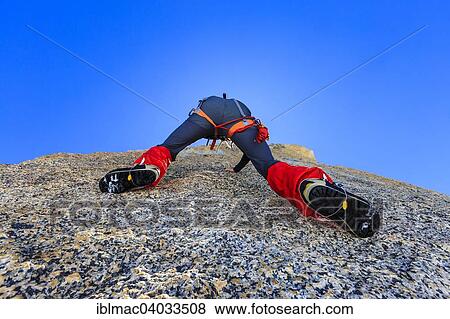 Stock Photo - "Climber climbing on a rock wall, alpine climb, Alps, Canton of Valais, Switzerland, Europe". Fotosearch