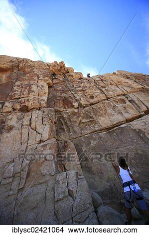 Climber climbing the Thin Wall climbing route in Joshua Tree National Park, Mojave Desert, California, USA View Large Photo Image Picture - Climber climbing the Thin Wall climbing route in Joshua Tree National Park, Mojave Desert, California, USA. Fotosearch