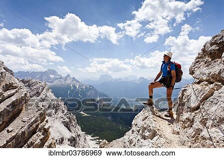 "Climber descending from Monte Cristallo on the Via ferrata Ivano Dibona, behind the Pelmo, Dolomites of Ampezzo, Belluno, Italy, Europe" View Large Photo Image Stock Photo - "Climber descending from Monte Cristallo on the Via ferrata Ivano Dibona, behind the Pelmo, Dolomites of Ampezzo, Belluno, Italy, Europe". Fotosearch