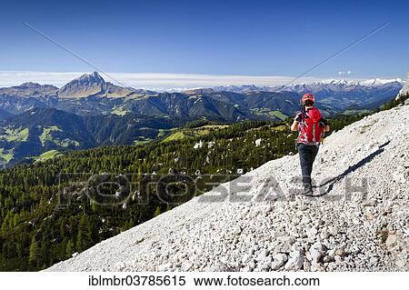 Stock Photography - "Climber descending over the Heiligkreuzkofelsteig trail from Heiligkreuzkofel in the Fanes in the Fanes-Senes-Prague, below the Val Badia, in the back the Peitlerkofel, Alta Badia, Dolomites, South Tyrol, Italy, Europe". Fotosearch