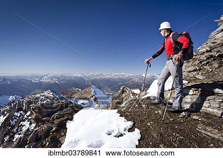 Stock Image - "Climber on the summit ridge of the Wilde Kreuzspitze in the Pfunderer mountains, behind the Wipptal valley, Eisacktal, South Tyrol, Italy, Europe". Fotosearch