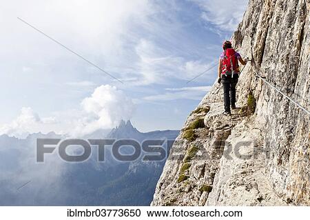 Stock Image - "Climber on the Via Ferrata Giuseppe di Olivieri, Dolomites, Belluno, Italy, Europe". Fotosearch