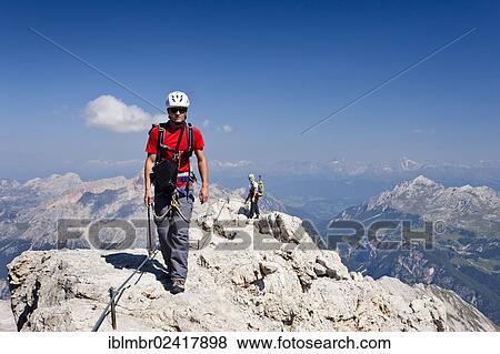 Climber on the way down from the summit of Cristallo di Mezzo mountain, here on Monte Cristallo mountain on the Marino Bianchi fixed rope route, Belluno, Dolomites, Italy, Europe View Large Photo Image Stock Photo - Climber on the way down from the summit of Cristallo di Mezzo mountain, here on Monte Cristallo mountain on the Marino Bianchi fixed rope route, Belluno, Dolomites, Italy, Europe. Fotosearch