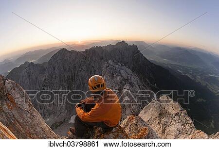 "Climber sitting on the top of Ellmauer Halt at sunrise, Ellmau, Wilder Kaiser, North Tyrol, Austria, Europe" View Large Photo Image Stock Image - "Climber sitting on the top of Ellmauer Halt at sunrise, Ellmau, Wilder Kaiser, North Tyrol, Austria, Europe". Fotosearch