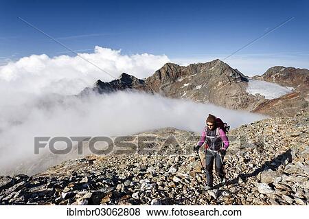 Stock Photo - "Climber trying to climb Fernerkoefl Mountain in the Rieserferner Group, Pustertal, South Tyrol province, Trentino-Alto Adige, Italy, Europe". Fotosearch
