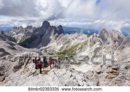 "Climbers climbing Kesselkogel mountain via the fixed rope route above the Grasleitenpass, Rosengarten group at the back, province of Trentino, Italy, Europe" View Large Photo Image Stock Photography - "Climbers climbing Kesselkogel mountain via the fixed rope route above the Grasleitenpass, Rosengarten group at the back, province of Trentino, Italy, Europe". Fotosearch