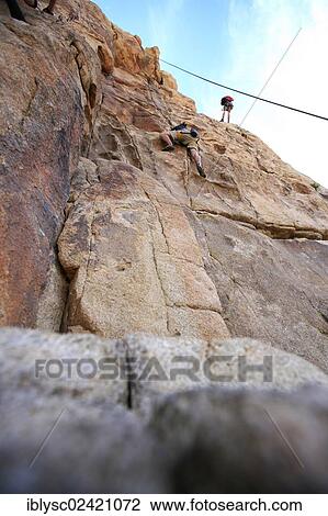 Climbers climbing the Thin Wall climbing route in Joshua Tree National Park, Mojave Desert, California, USA View Large Photo Image Stock Image - Climbers climbing the Thin Wall climbing route in Joshua Tree National Park, Mojave Desert, California, USA. Fotosearch