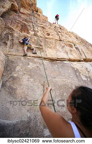 Climbers climbing the Thin Wall climbing route in Joshua Tree National Park, Mojave Desert, California, USA View Large Photo Image Stock Photo - Climbers climbing the Thin Wall climbing route in Joshua Tree National Park, Mojave Desert, California, USA. Fotosearch