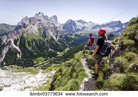 Picture - "Climbers on the descent, Via Ferrata dei Finanzieri in Val di Fassa, Mt Gran Vernel and the Mt Marmolada south face at back, Dolomites, Trentino, Italy, Europe". Fotosearch