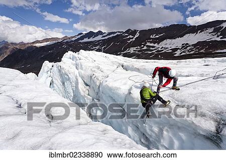 Stock Image - "Climbers performing a crevasse rescue Zufallferner Glacier in the Martell Valley above Marteller Huette hut, Alto Adige, Italy, Europe". Fotosearch