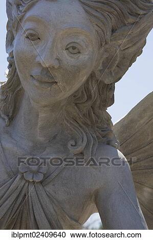 "Close-up of a female like statue with wings in the Fairy garden at the """"Route des Gerbes d'Angelica"""" garden in Mirabel, Laurentians, Quebec, Canada - This image is property released for book, calendar, magazine, newspaper and editorial use only. " View Large Photo Image Stock Image - "Close-up of a female like statue with wings in the Fairy garden at the """"Route des Gerbes d'Angelica"""" garden in Mirabel, Laurentians, Quebec, Canada - This image is property released for book, calendar, magazine, newspaper and editorial use only. ". Fotosearch