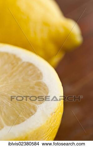 Picture - "Close up of two lemons, one cut in half". Fotosearch