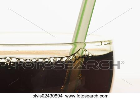 Closeup of a glass of cola with a drinking straw View Large Photo Image Picture - Closeup of a glass of cola with a drinking straw. Fotosearch