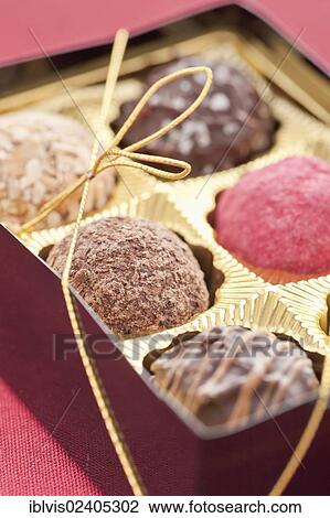 Closeup of chocolate truffles in a box of chocolates View Large Photo Image Stock Image - Closeup of chocolate truffles in a box of chocolates. Fotosearch
