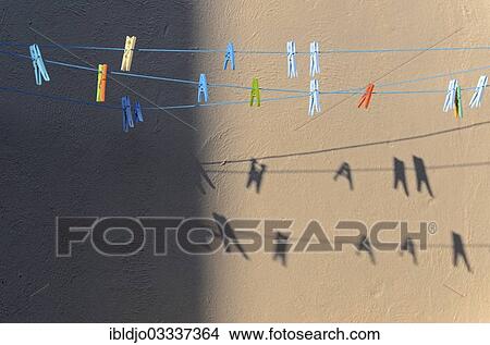 "Clothes-pegs on washing lines and their shadow on a wall, Piana, Corsica, France, Europe" View Large Photo Image Picture - "Clothes-pegs on washing lines and their shadow on a wall, Piana, Corsica, France, Europe". Fotosearch
