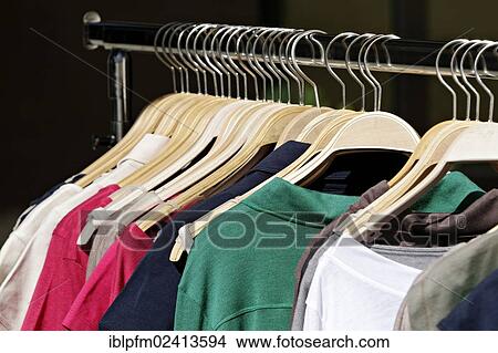 Clothing hanging on clothes rack View Large Photo Image Picture - Clothing hanging on clothes rack. Fotosearch