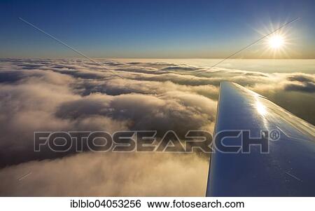 "Cloud cover above Winterberg, right wing of airplane, sunset, blue sky, Winterberg, Hochsauerland district, Sauerland, North Rhine-Westphalia, Germany, Europe" View Large Photo Image Stock Photograph - "Cloud cover above Winterberg, right wing of airplane, sunset, blue sky, Winterberg, Hochsauerland district, Sauerland, North Rhine-Westphalia, Germany, Europe". Fotosearch
