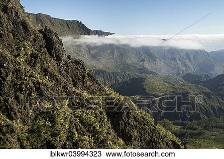 Stock Image - "Clouds above Mafate basin, Cirque de Mafate, Reunion, Africa". Fotosearch