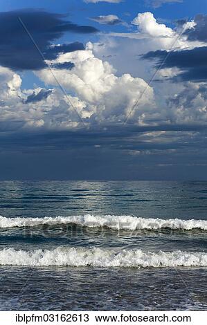 Stock Image - "Clouds, coastal waves, Augusta, Western Australia". Fotosearch