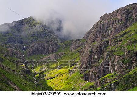 Stock Photo - "Clouds hanging over the mountains at the Tree Sisters, Glen Coe, Ross Skye and Lochaber, Scottish Highlands, Scotland, United Kingdom, Europe". Fotosearch
