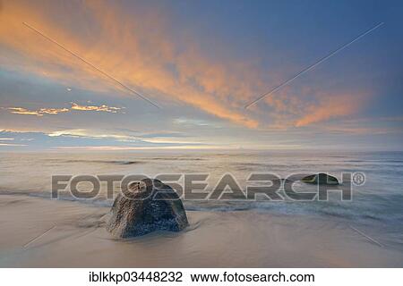 "Clouds illuminated by the sun in the sky at sunset, stones on the beach, Dranske, Mecklenburg-Western Pomerania, Germany, Europe" View Large Photo Image Stock Image - "Clouds illuminated by the sun in the sky at sunset, stones on the beach, Dranske, Mecklenburg-Western Pomerania, Germany, Europe". Fotosearch