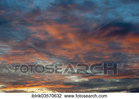 Stock Image - Clouds in the sky at sunset. Fotosearch