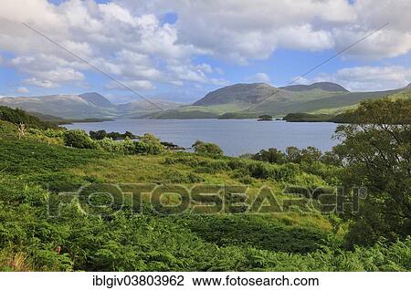 Stock Image - "Clouds over the freshwater Loch Assynt, Sutherland, Highland, Scotland, United Kingdom, Europe". Fotosearch