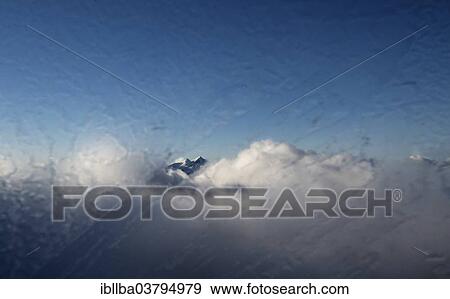 Stock Photo - "Clouds passing over the mountain peaks, seen through the frosted pane of a gondola, Zugspitze, Bavaria, Germany, Europe". Fotosearch