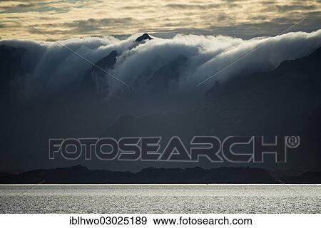 Stock Photo - "Clouds rolling over mountains, evening mood, Vestfjord at front, Svolvaer, Lofoten/ Vestfjord, Nordland, Northern Norway, Norway, Europe". Fotosearch