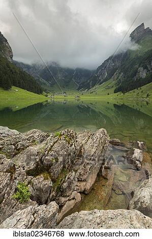 "Cloudy mood over Lake Seealpsee in Alpstein, Appenzellerland, Switzerland, Europe" View Large Photo Image Stock Photo - "Cloudy mood over Lake Seealpsee in Alpstein, Appenzellerland, Switzerland, Europe". Fotosearch