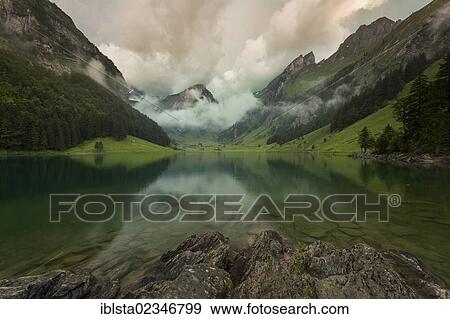 "Cloudy mood over Lake Seealpsee in Alpstein, Appenzellerland, Switzerland, Europe" View Large Photo Image Stock Photo - "Cloudy mood over Lake Seealpsee in Alpstein, Appenzellerland, Switzerland, Europe". Fotosearch