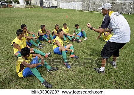 Stock Photo - "Coach giving young players technical instructions, preparation for the Street Children World Cup 2014, Fortaleza, Ceara, Brazil, South America". Fotosearch