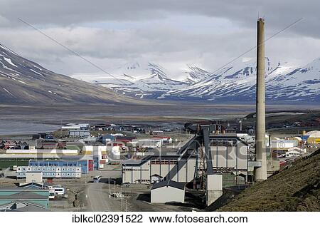 Stock Image - "Coal power plant in Longyearbyen in the industrial area of the city against the backdrop of the mountains of the Adventdalen valley, Spitsbergen, Svalbard, Norway, Europe". Fotosearch