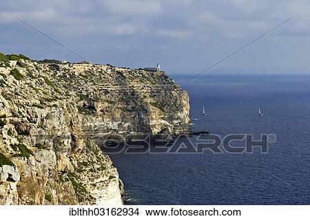 Picture - "Coastal cliffs with a lighthouse at Cabo Blanco, Tolleric, Majorca, Balearic Islands, Spain, Europe". Fotosearch