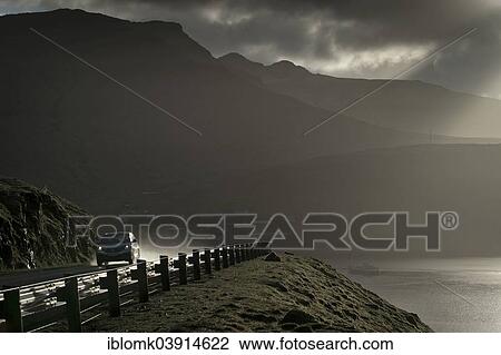 "Coastal road, wet with rain, Sundini straight, Streymoy, Faroe Islands, Denmark, Europe" View Large Photo Image Stock Image - "Coastal road, wet with rain, Sundini straight, Streymoy, Faroe Islands, Denmark, Europe". Fotosearch