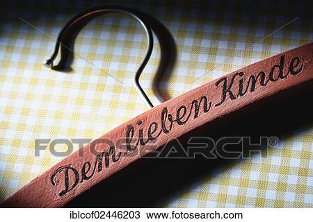 "Coat hanger with the words """"Dem lieben Kinde"""" or """"for the dear child"""", symbolic image for corporal punishment" View Large Photo Image Stock Image - "Coat hanger with the words """"Dem lieben Kinde"""" or """"for the dear child"""", symbolic image for corporal punishment". Fotosearch