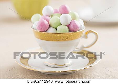 Coffee cup filled with candy View Large Photo Image Stock Photograph - Coffee cup filled with candy. Fotosearch