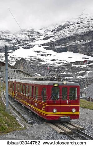 Stock Image - "Cog railway, Jungfrau Railway below the Eiger North Face, Kleine Scheidegg, Grindelwald, Berner Oberland, Berner Alpen, Canton of Bern, Switzerland, Europe". Fotosearch