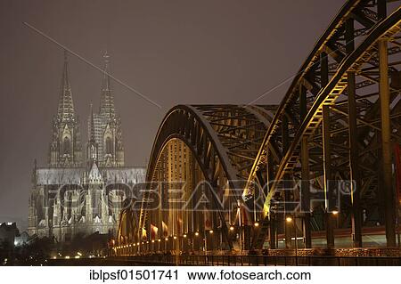 "Cologne Cathedral and Hohenzollern Bridge illuminated in Winter, Cologne, North Rhine-Westphalia, Germany, Europe" View Large Photo Image Stock Image - "Cologne Cathedral and Hohenzollern Bridge illuminated in Winter, Cologne, North Rhine-Westphalia, Germany, Europe". Fotosearch