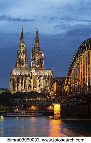 "Cologne Cathedral with Hohenzollern Bridge at dusk, the Rhine at the front, Cologne, North Rhine-Westphalia, Germany, Europe" View Large Photo Image Stock Image - "Cologne Cathedral with Hohenzollern Bridge at dusk, the Rhine at the front, Cologne, North Rhine-Westphalia, Germany, Europe". Fotosearch