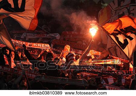 Stock Photo - "Cologne fans burning flares, Esprit Arena, Dusseldorf, North Rhine-Westphalia, Germany, Europe". Fotosearch