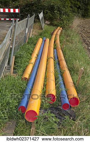 Stock Photo - "Colored plastic pipes lying on a construction site, renewal of supply lines, Im Telgei street, Dortmund, Ruhr area, North Rhine-Westphalia, Germany, Europe, PublicGround, Europe". Fotosearch