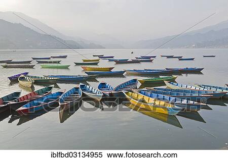 "Colorful boats on Phewa Lake, hills and clouds in the back, Pokhara, Nepal, Asia" View Large Photo Image Stock Photography - "Colorful boats on Phewa Lake, hills and clouds in the back, Pokhara, Nepal, Asia". Fotosearch