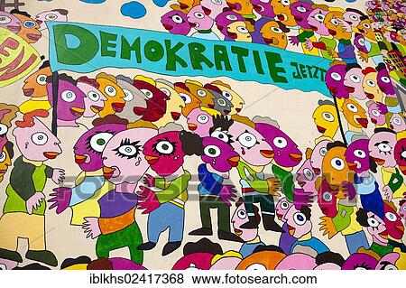 Colorful drawing of people, lettering Demokratie jetzt, German for Democracy now on a wall in Bruehl street, Leipzig, Saxony, Germany, Europe View Large Photo Image Stock Photo - Colorful drawing of people, lettering Demokratie jetzt, German for Democracy now on a wall in Bruehl street, Leipzig, Saxony, Germany, Europe. Fotosearch
