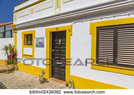 Stock Image - "Colorful house with ceramic tiles, Azulejos, Ferragudo, Algarve, Portugal, Europe". Fotosearch