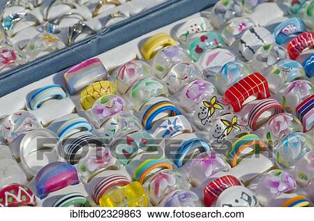 Stock Image - "Colorful plastic rings for sale at the weekly flea market, Dresden, Saxony, Germany, Europe". Fotosearch
