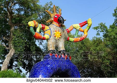 Stock Image - "Colorful sculpture in the Giardino dei Tarocchi or Garden of the Tarot, by Niki de Saint Phalle and Jean Tinguely in Capalbio, Province of Grosseto, Tuscany, Italy, Europe". Fotosearch