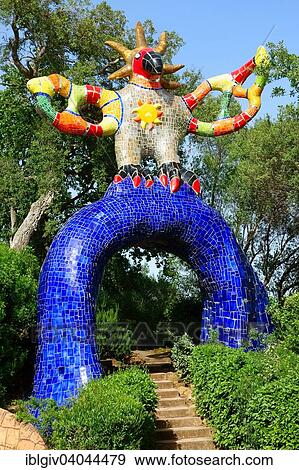 Stock Photo - "Colorful sculpture in the Giardino dei Tarocchi or Garden of the Tarot, by Niki de Saint Phalle and Jean Tinguely in Capalbio, Province of Grosseto, Tuscany, Italy, Europe". Fotosearch
