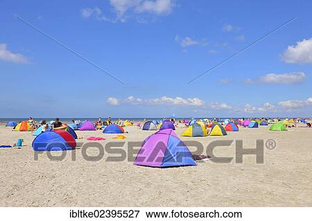 "Colorful wind screens on the beach of St. Peter-Ording, Schleswig-Holstein, Germany, Europe" View Large Photo Image Stock Photo - "Colorful wind screens on the beach of St. Peter-Ording, Schleswig-Holstein, Germany, Europe". Fotosearch