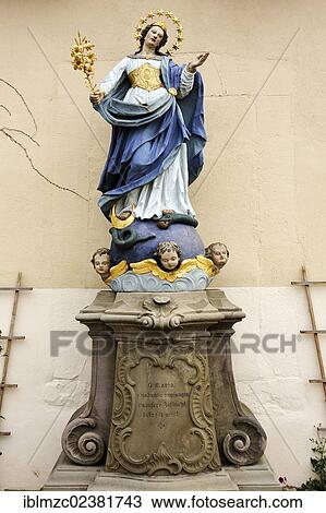 "Coloured sculpture of Mary Immaculate with her foot resting on the head of a snake winding around a globe, Bergrheinfeld, Lower Franconia, Bavaria, Germany, Europe" View Large Photo Image Stock Image - "Coloured sculpture of Mary Immaculate with her foot resting on the head of a snake winding around a globe, Bergrheinfeld, Lower Franconia, Bavaria, Germany, Europe". Fotosearch